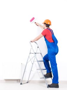 worker is painting the walls